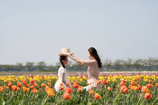 beautiful asian girl with mother  in the flower field