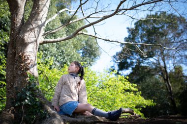 Ağacın gölgesinde dinlenen bir kız.