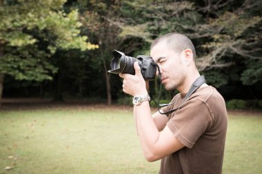 Adam kamera önünde fotoğraf çekiyor. 