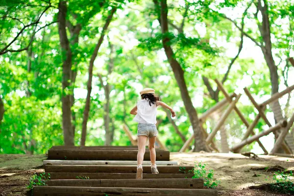 Girl walking up the stairs in the forest