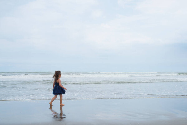 Girl playing on the beach 