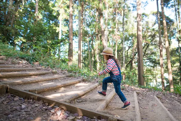 girl  hiking with wooden stairs in forest