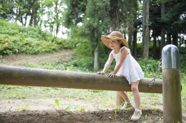 Parkta oynayan Asyalı küçük kız. 