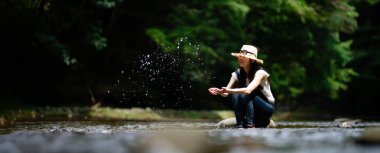 Dağın deresinde dinlenen bir kadın.