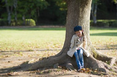 Parktaki ağaçtaki genç kız.