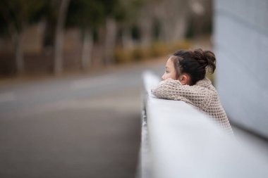 Şirin küçük çocuk caddeye bakıyor.