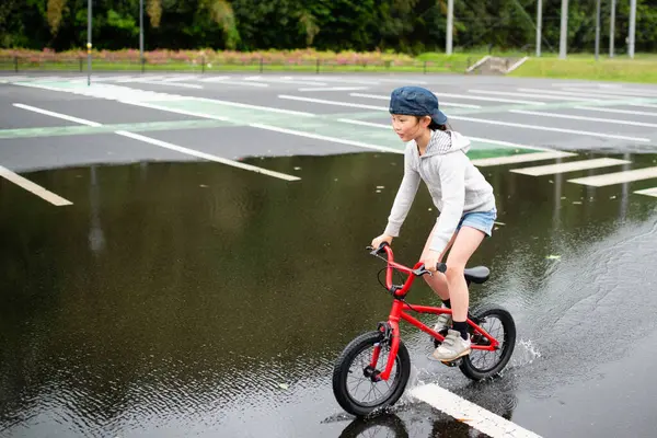 stock image cute little asian girl  riding a bicycle in the park