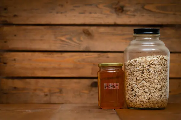 jar with oat seeds  on wooden background