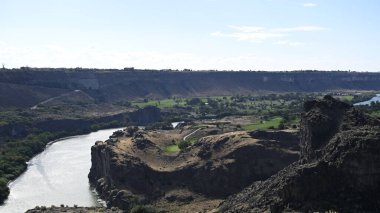 Nehir vadide. Sakin dağ nehri. Volkanik bir geçitte nehir. Amerika 'nın doğası. Idaho 'nun doğası. Twin Falls kasabası. Volkanik kayalar. Nehrin kayalık kıyıları. Kuzey Amerika doğası. Doğa manzarası. Dağ nehri manzarası. Kanyon.