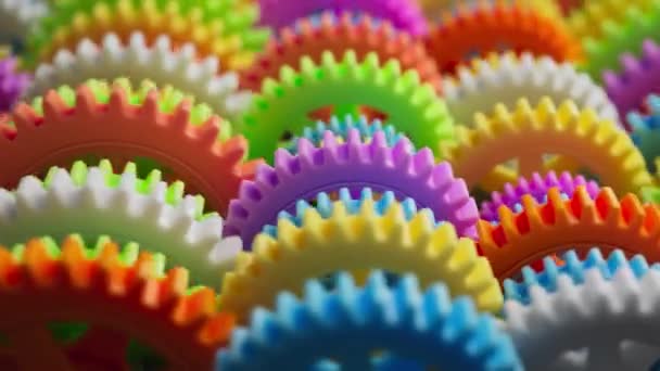 Looping Animation Group Multi Colored Plastic Toy Gears Close Defocus — Stock Video