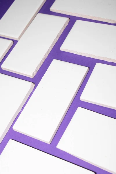 A White Abstract Shaped Tiles On a Coloured Background Close Up