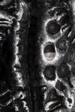 A Alien trypophobia holes in a shiny sci-fi close up background