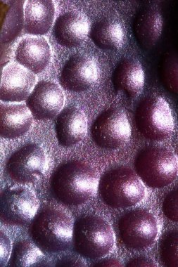 A Alien trypophobia holes in a shiny sci-fi close up background
