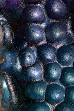 A Alien trypophobia holes in a shiny sci-fi close up background