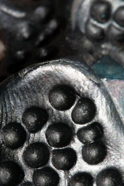 A Alien trypophobia holes in a shiny sci-fi close up background