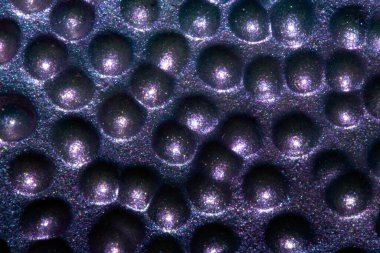 A Alien trypophobia holes in a shiny sci-fi close up background clipart