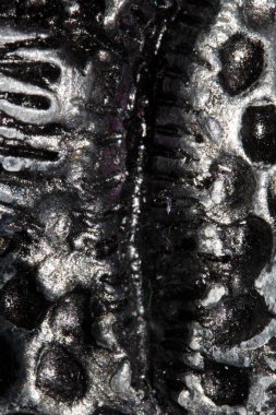 A Alien trypophobia holes in a shiny sci-fi close up background