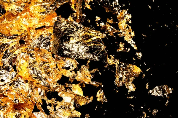 Vibrant Gold Leaf Pieces Close Up on A Background as Decorative Pieces