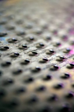 Close Up of a Steel Metal Perferated Hole Background Abstract Futeristic Circles