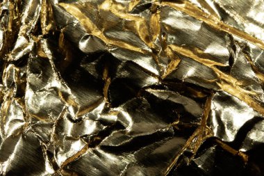 Jagged Crumpled and Creased Gold Shiny Metal Metallic Background clipart