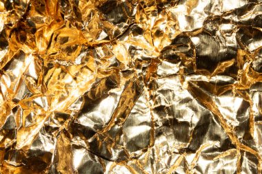 Jagged Crumpled and Creased Gold Shiny Metal Metallic Background clipart