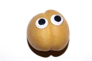 Close up of a fresh apricot fruit with Boggle Eyes Silly clipart