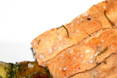 Close up of freshly baked focaccia bread  with salt and rosemary clipart