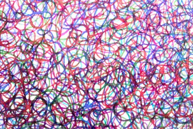 Coloured ink pen scribbled wavy messy tengled lines on white background