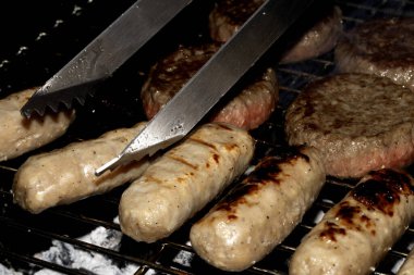 Barbeküye yakın açık hava yemekleri, ızgarada pişmiş sosisli sandviçler.