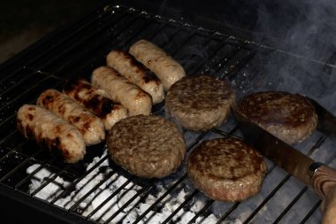 Barbeküye yakın açık hava yemekleri, ızgarada pişmiş sosisli sandviçler.