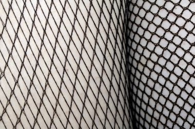 Cilt üzerindeki siyah balık ağı taytlarının kapanışı bacak kıvrımları soyut arkaplan kıvrımları yapar