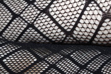 Cilt üzerindeki siyah balık ağı taytlarının kapanışı bacak kıvrımları soyut arkaplan kıvrımları yapar