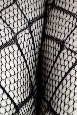 Cilt üzerindeki siyah balık ağı taytlarının kapanışı bacak kıvrımları soyut arkaplan kıvrımları yapar