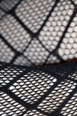 Cilt üzerindeki siyah balık ağı taytlarının kapanışı bacak kıvrımları soyut arkaplan kıvrımları yapar