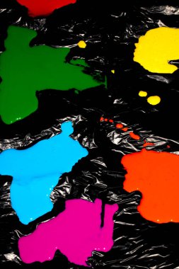 Siyah plastik arka plan soyut arkaplan üzerine ıslak akrilik renkli boya sıçraması