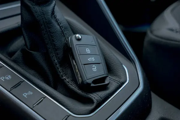 Modern car key near gear gear shifter selector