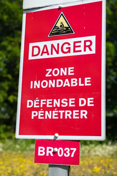 Prevention of accidental drownings in watercourses and water reservoirs. Flood zone danger sign, no entry. Normandy, France, June 2021