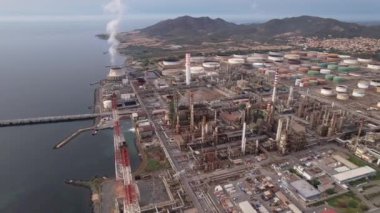 İtalya 'nın Sardunya kentindeki büyük bir termik santral ve sanayi bölgesinin hava görüntüsü. Santral kıyıda yer almakta ve çok sayıda büyük tank ve bacası bulunmaktadır..