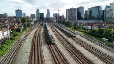 Brüksel Nord tren istasyonuna giden çok sayıda tren yolunun görüntüsü. İstasyon arka planda, yüksek binalarla çevrili..