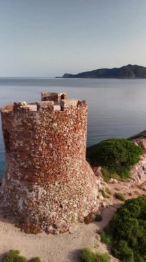 Sardunya 'nın nefes kesici sahil şeridini keşfedin. Gün batımında sakin denizin yanında tarihi bir gözlem kulesi bulundurun..