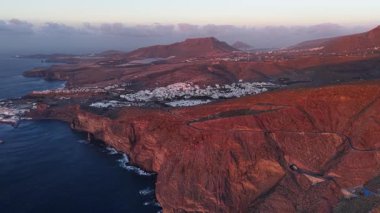 Gün batımında Gran Canaria 'daki Tamadaba Doğal Parkı' nın nefes kesici hava manzarasını izleyin. Engebeli kayalıklara ve dingin kıyı şeridine hayret gün batımında aydınlanıyor..