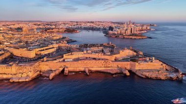 Malta 'nın başkenti Valletta' nın nefes kesici hava perspektifini, tarihi binalarını, canlı rıhtımını ve şehrin ufuk çizgisi ve kıyı şeridi üzerinde çarpıcı gün batımı parıltısını deneyimleyin..