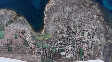 Maltas tuz tavalarının nefes kesici hava perspektifini keşfedin. Karmaşık desenleri ve canlı renkleri vurgulayın..
