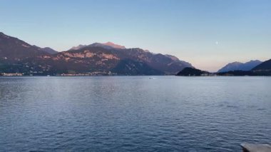 Alacakaranlıkta İtalya 'daki Como Gölü' nün nefes kesici hava manzaralarını keşfedin, görkemli dağlarla çevrili sakin suları ortaya çıkarın. Huzurlu atmosferi ve çarpıcı manzaraları tecrübe edin..