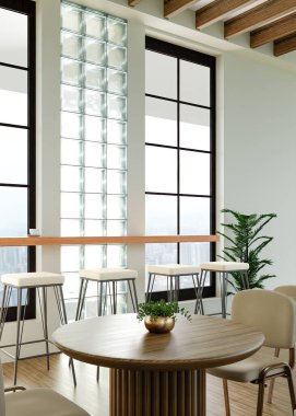 Minimalist mobilyalar, doğal ışık ve yeşil bitkilerin yer aldığı çağdaş bir iç tasarım..