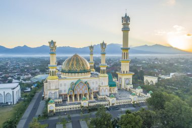 Mataram, 28 July 2021, Islamic center Lombok, Indonesia. Grand Mosque Stands Majestically at Sunrise with Scenic Mountain Backdrop Beautifully Displayed clipart