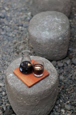 Brewing Coffee Enhances Flavor with Unique Presentation on Stone Outdoors clipart