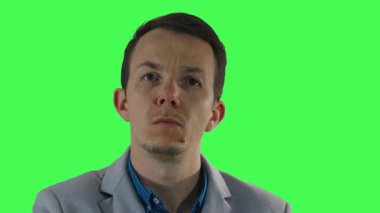 Düşünceli erkek profesyonel görünmeyen ekran ile etkileşim içinde gibi davranır, çeşitli duygusal ifadeleri ve hareketleri pazarlama, iletişim veya UI / UX temaları için kullanılan kroma anahtar arkaplan önünde yürütür ve gerçekleştirir