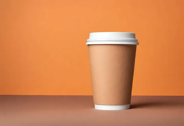 Paper cup of coffee on the table. Coffee paper cup mockup. isolated on orange background, v15