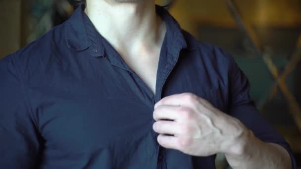 Young Man Unbuttoning Blue Shirt Close — Stock Video